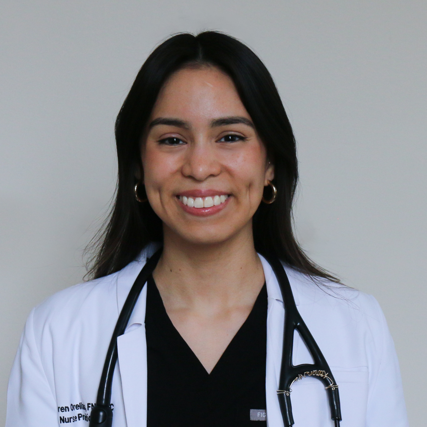 Smiling nurse in white coat with stethoscope